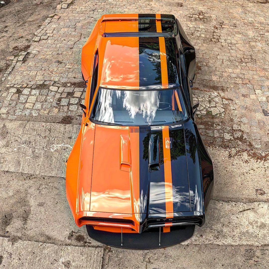 lamtac close up of the curved orange black double sided pontiac gto mustang showing off its powerful muscles 653cef82a895e Close-up Of The Curved Orange/black Double-sided Pontiac GTO Mustang Showing Off Its Powerful Muscles