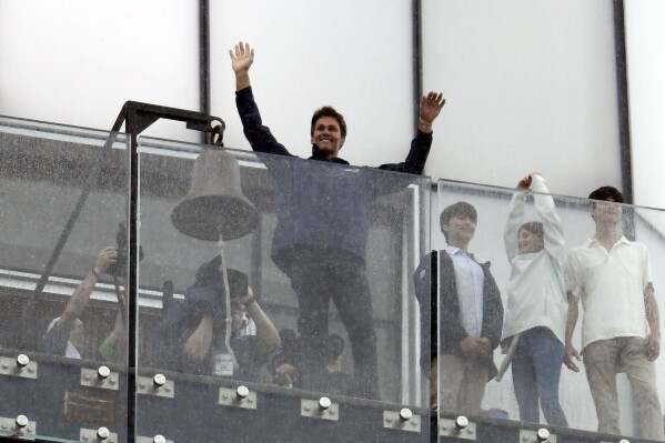 Former NFL quarterback Tom Brady, center, waves from the lighthouse at Gillette Stadium prior to an NFL football game between the Philadelphia Eagles and the New England Patriots, Sunday, Sept. 10, 2023, in Foxborough, Mass. (AP Photo/Mark Stockwell)