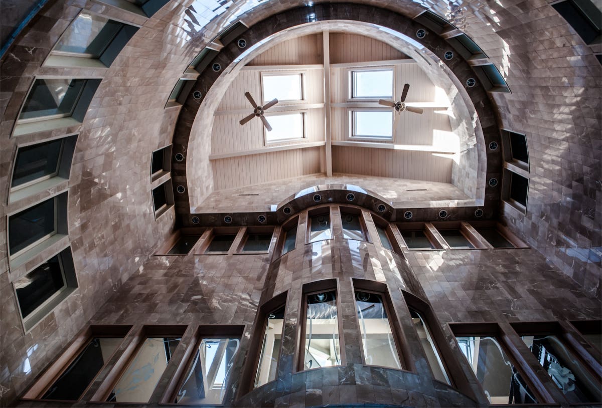 Soaring cathedral atrium skylight, bathed in marble