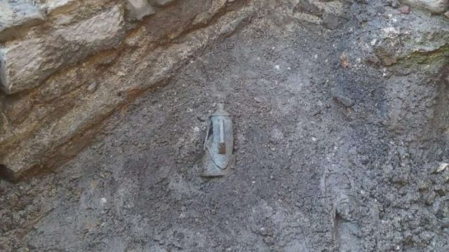 The ministry shared photos of the shiny coins, which were spilling out of an amphora — a Roman jar with two handles — buried in the dirt. Credit: Italian Ministry of Culture