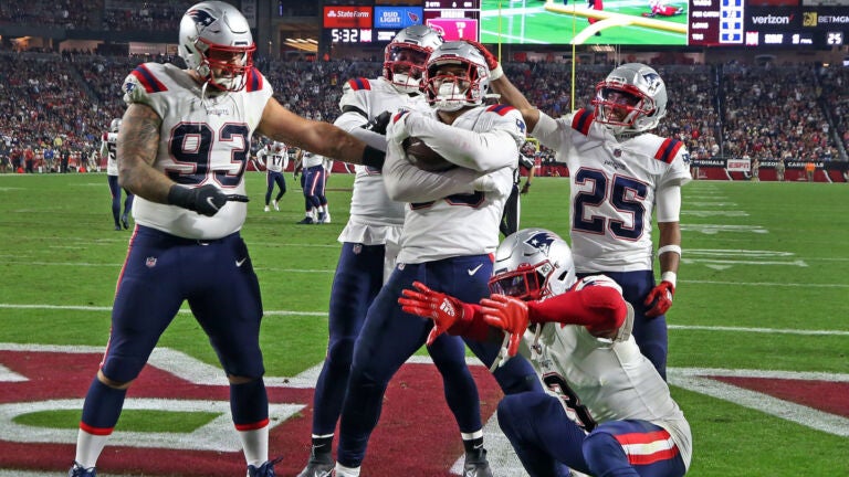 The Patriots Raekwon McMillan (center) and some of his teammates mug it up for the Monday Night Football camera after he returned a third quarter Arizona fumble for a touchdown. The scoreboard behind them is showing the replay of the play and the score reflects the fact that New England had just taken a lead they would not lose. The New England Patriots visited the Arizona Cardinals for an NFL Monday Night Football game at State Farm Stadium.